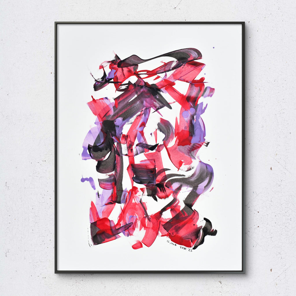 Abstract art with red and purple brush strokes in a black frame on a white wall.