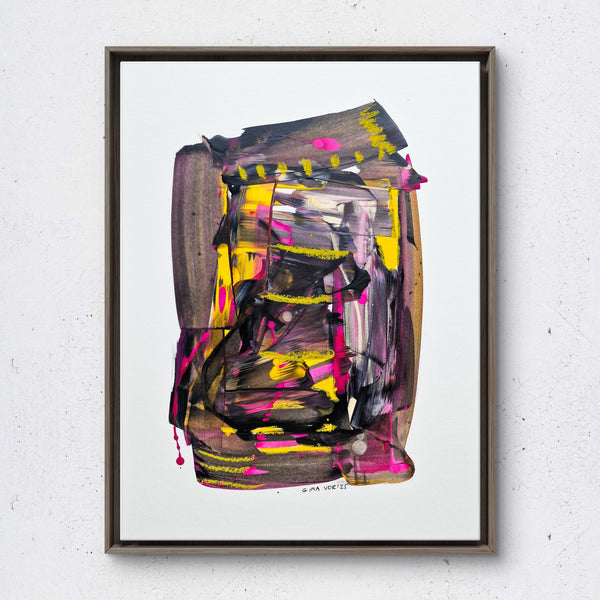 Abstract painting with vibrant colors in a black frame on a white wall