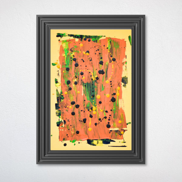 A framed abstract painting featuring a textured orange and yellow background with green and black paint splatters, enclosed in a dark gray frame against a white wall.