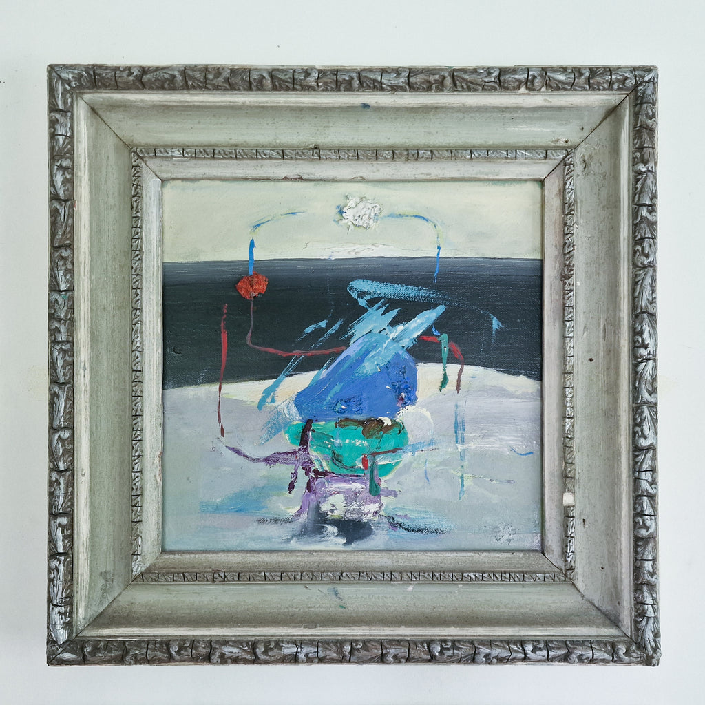 A framed abstract painting featuring a central blue and teal form with red, purple, and light blue brushstrokes against a dark blue and white background, enclosed in an ornate distressed silver frame.