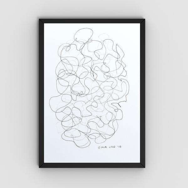 A framed abstract line art featuring a black continuous scribble pattern on a white background, enclosed in a slim black frame and mounted on a light gray wall.