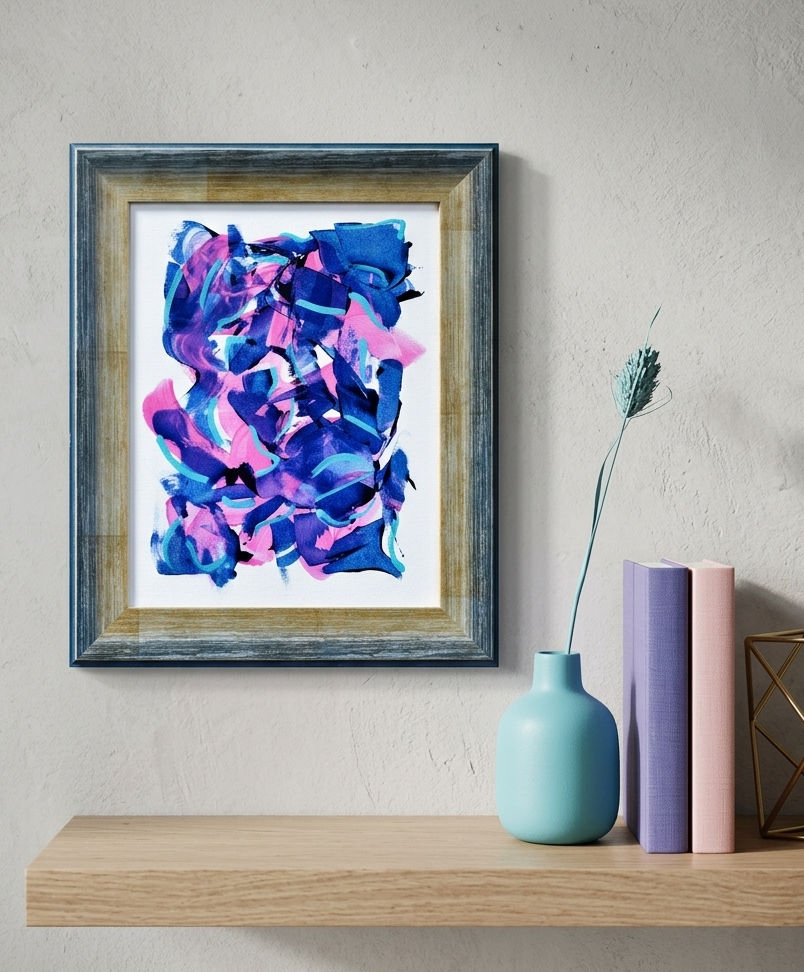 Framed abstract art piece on a wall above a shelf with decorative vases.