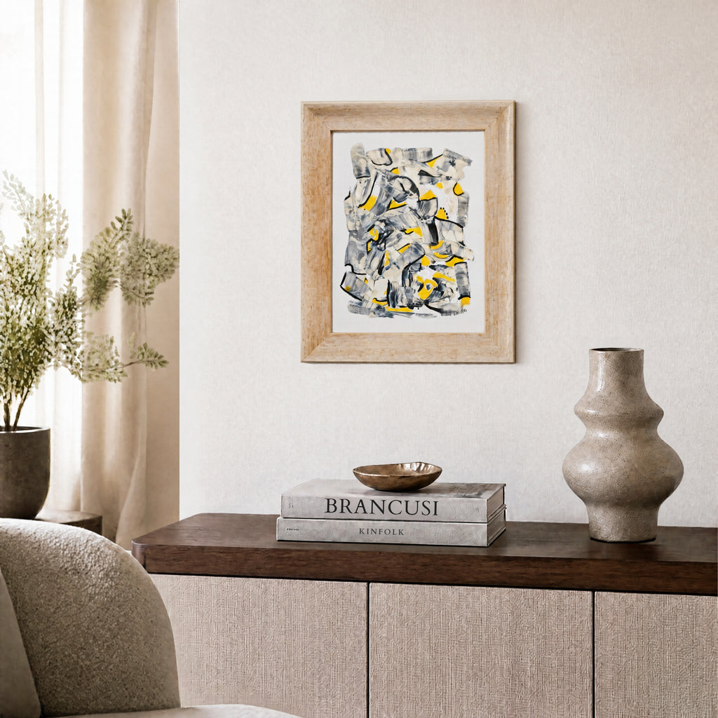 Small framed abstract artwork in contemporary interior
