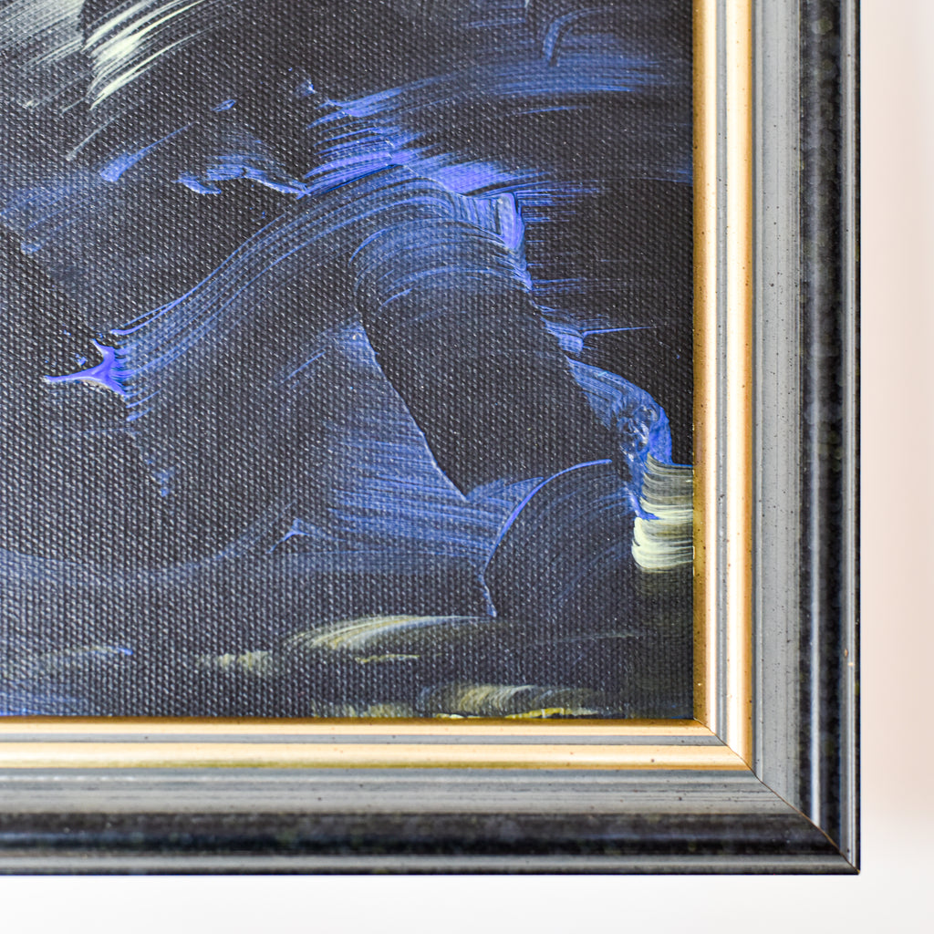 Abstract painting with blue and black strokes in a gold frame.