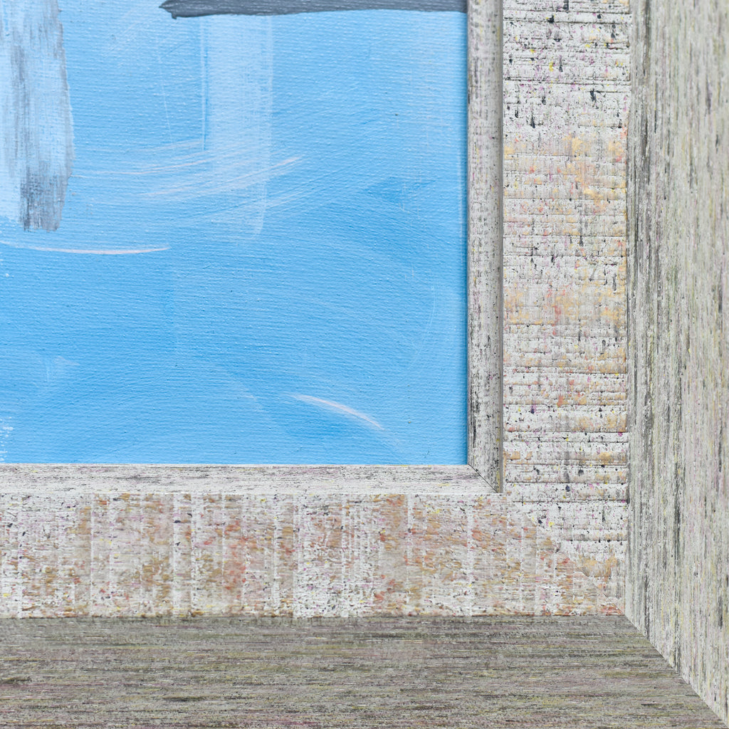 Close-up of a textured wall with a blue section and a brick-patterned frame.