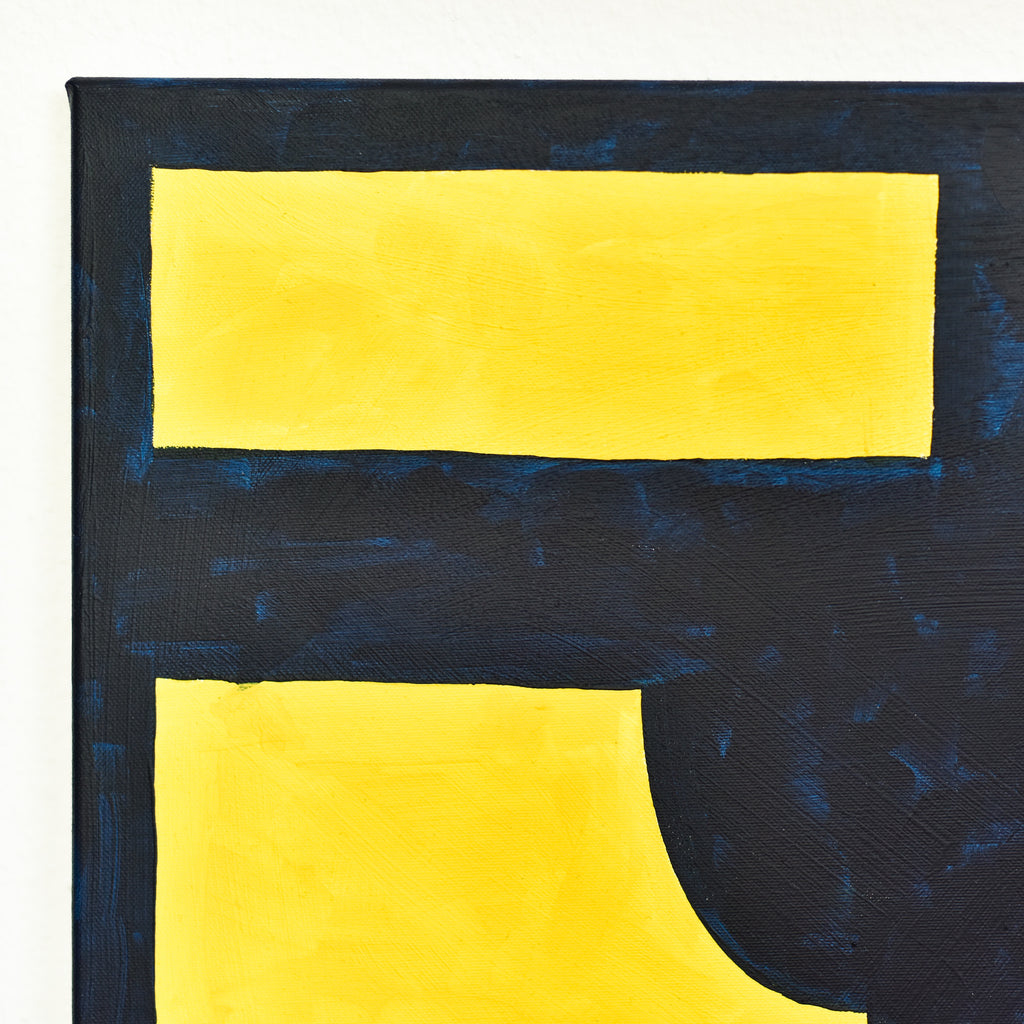 Close-up of an abstract artwork featuring dark blue and bold yellow geometric shapes.