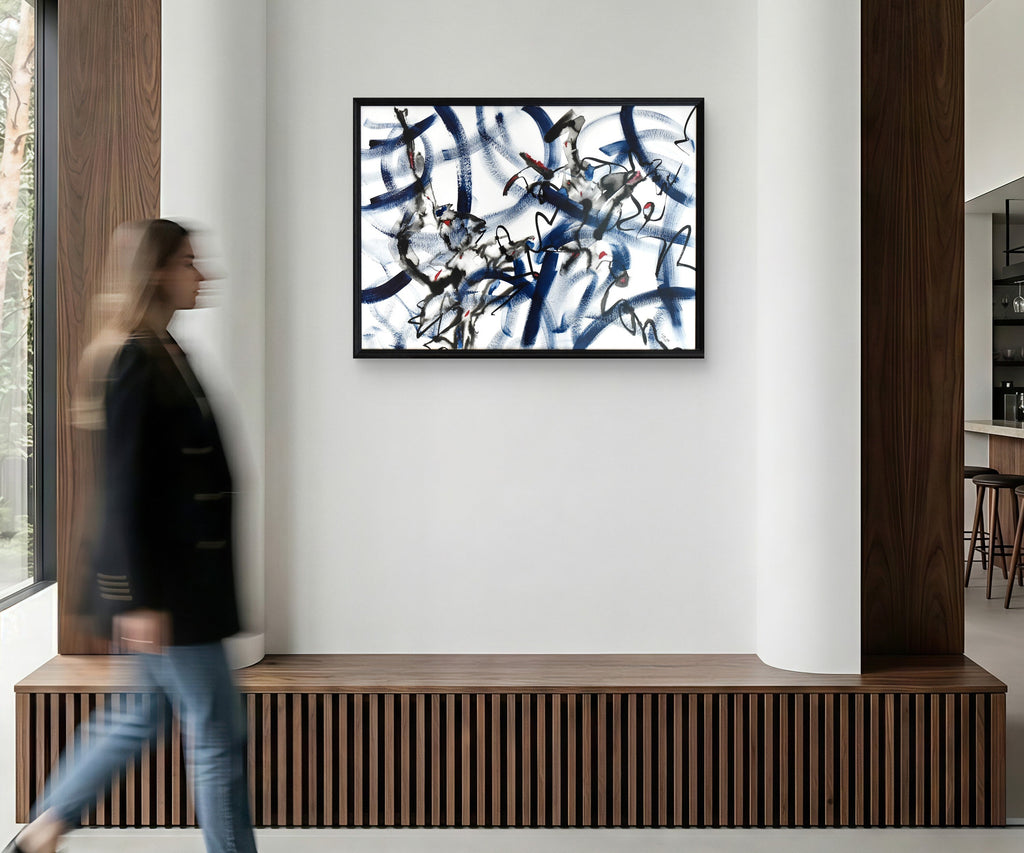 Abstract art piece on a wall in a modern interior setting with a person walking by.