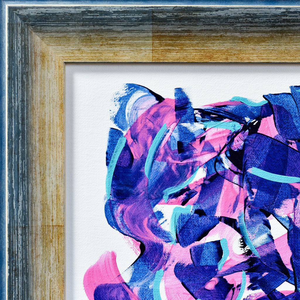 Abstract art piece with pink and blue colors in a gold frame.