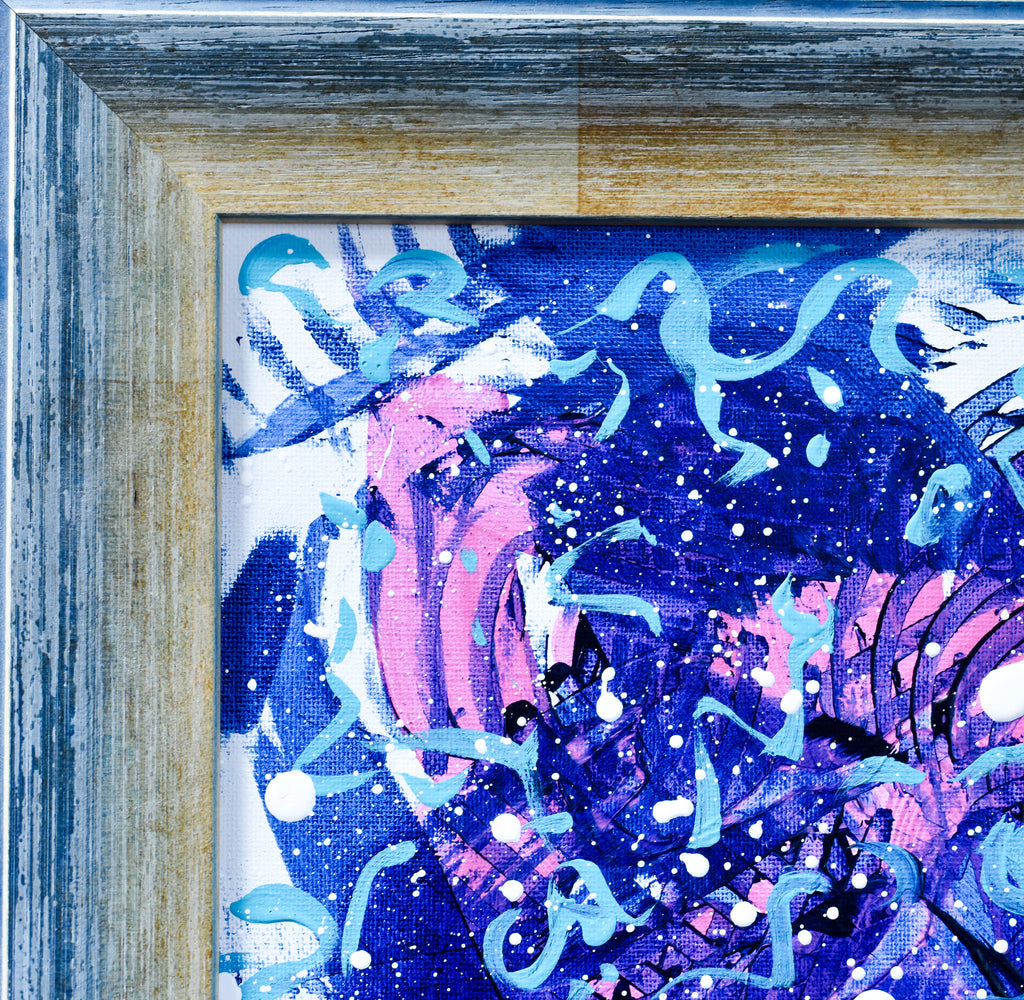 Framed abstract artwork with pink and blue elements
