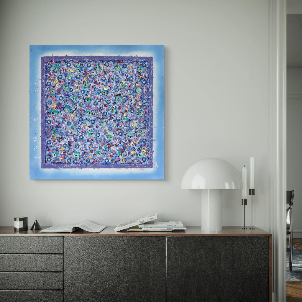 Decorative abstract painting on a wall above a wooden cabinet.